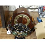 An Art Deco Polished Mantel Clock With Circular Dial, Together With A Victorian Black Lustre Teapot