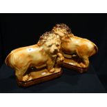 A Pair Of Early 20th Century Staffordshire Pottery Standing Lions With Inset Glass Eyes, 11" High