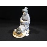 A Lladro Porcelain Figure Of Oriental Lady Taking Tea