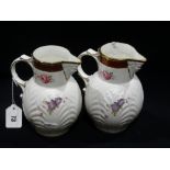 A Pair Of Coalport Mask Head Jugs With Floral Sprays