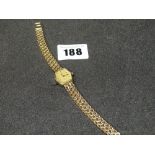 A 9ct Gold Encased Marvin Ladies Wrist Watch On A 9ct Gold Bracelet