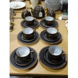 A Twenty-One Piece Black & Gold Eggshell China Tea Set