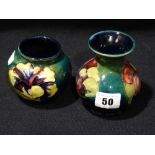 Two Moorcroft Pottery Green Ground Floral Decorated Squat Vases, Both Retaining Paper Labels To The