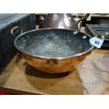 A Copper Circular Cooking Vessel With Twin Brass Handles