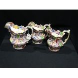 Three Matching Staffordshire Pottery Mask Head Jugs With Floral Transfer Decoration