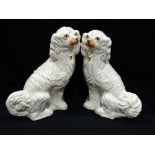 A Pair Of Staffordshire Pottery White Seated Dogs