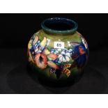 A Circular Based Green Ground Moorcroft Pottery Bulbous Vase, With Floral Band, Signed To The Base,