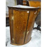 An Antique Oak Bow Front Two Door Hanging Corner Cupboard