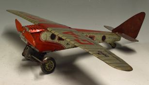 Mettoy K2010 Tinplate Clockwork Aircraft made in Great Britain silver with red decals, wear in