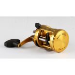 Penn International 975 LD Baitcast Fishing Reel finished in gold, made in U.S.A, soft grip handle,