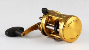 Penn International 975 LD Baitcast Fishing Reel finished in gold, made in U.S.A, soft grip handle,