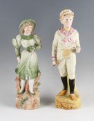 Pair Continental Bisque Tennis figures c. 1900 – of a young couple each holding early rackets and