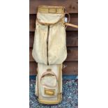 Canvas and leather cream coloured golf bag with the makers triangular logo stamped to the base (