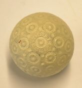 The Eclipse with recessed ring and doughnut pattern rubber core golf ball – retaining near all white