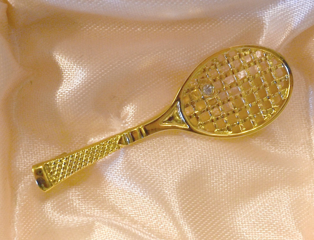 Modern Tennis Brooch in gold gilt a single tennis racket with jewelled tennis ball, has pin to