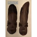 Pair of Biafran (Nigerian Tribe) male genitalia masks in carved and part stained hardwood (used as a