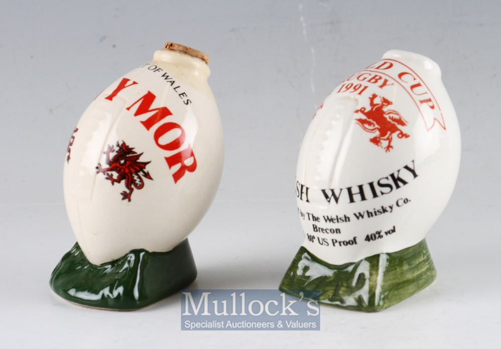 Two small empty Welsh Swn-y-Mor white ceramic Whisky Bottles in Rugby Ball shape, one for the