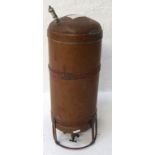 FRENCH COPPER WATER CYLINDER with a cylindrical body and lower valve tap, mounted on a painted steel