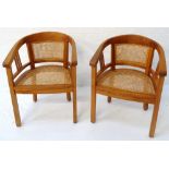 PAIR OF ELM ARM CHAIRS with hoop caned backs above caned seats, standing on plain supports