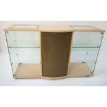 PALE OAK EFFECT DISPLAY CABINET with a shaped top with two inset glass panel sections above a