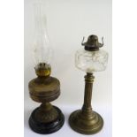 VICTORIAN OIL LAMP raised on a circular stepped base with twisted column to a glass reservoir;