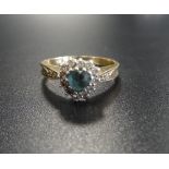 DIAMOND AND BLUE GEM SET CLUSTER RING the central heart cut blue gemstone in diamond surround and