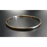 NINE CARAT GOLD BANGLE 6.7cm diameter and approximately 8.6 grams