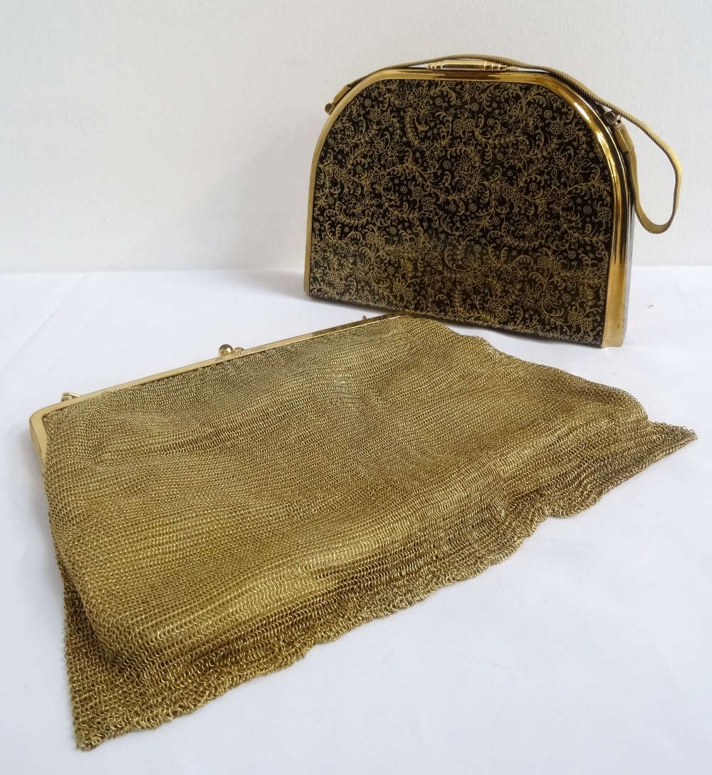 1950s HARD SHELL EVENING BAG BY STRATTON with floral gilt decoration on a black ground, opening to