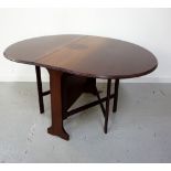 MAHOGANY GATE LEG DINING TABLE with shaped drop flaps, standing on shaped supports, 105cm wide