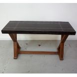LEATHER TOP SIDE TABLE with decorative geometric stitching, standing on X frame supports, 125cm wide