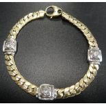 FOURTEEN CARAT TWO TONE GOLD BRACELET with three CZ set square links in white gold separated by