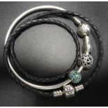 PANDORA MOMENTS SILVER BANGLE WITH STAR DECORATED CLASP and three charms; together with a black