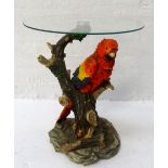 CIRCULAR GLASS TOP OCCASIONAL TABLE raised on a resin base modelled as a colourful Macaw on a