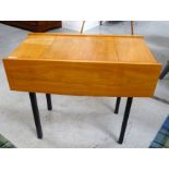 VINTAGE TEAK SEWING TABLE of oblong form with opposing end section drawers, standing on square block