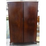 BEITHCRAFT MAHOGANY BOW FRONT WARDROBE with a moulded top above above two doors opening to reveal