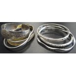 SEVEN SILVER BANGLES of various sizes and designs