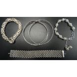 THREE SILVER BRACELETS AND AND A BANGLE comprising a Tabra mesh effect bracelet, a pierced ball