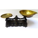 SET OF EARLY 20TH CENTURY SHOP SCALES with a shaped cast iron base with brass weighing and shaped