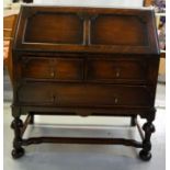 18th CENTURY STYLE OAK BUREAU with a panelled fall flap opening to reveal an inset tooled leather to