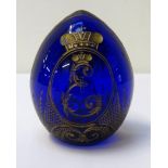 FABERGE CUT BLUE GLASS EGG WITH GILT DECORATION depicting a vase of flowers to one side and an E