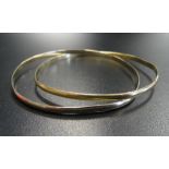 FOURTEEN CARAT GOLD BANGLE formed as two entwined bangles, approximately 10.9 grams