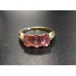 PINK SAPPHIRE AND DIAMOND RING the three oval cut sapphires flanked by small diamonds to the split