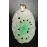 CARVED JADE PENDANT with stylised floral decoration, in unmarked gold mount, 3.7cm high excluding