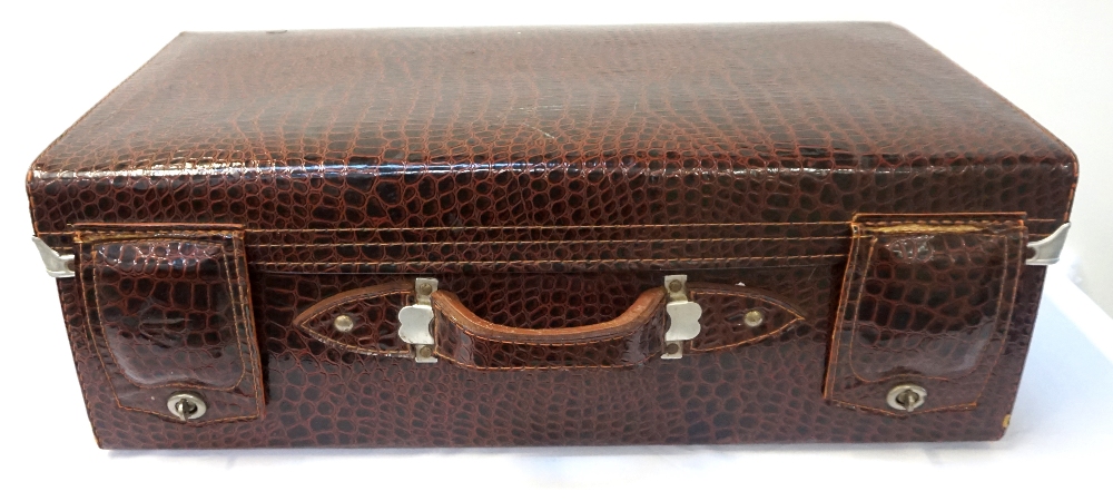 LEATHER CROCODILE EFFECT SUITCASE with a carry handle and fold over leather lock covers, with a part