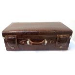 LEATHER CROCODILE EFFECT SUITCASE with a carry handle and fold over leather lock covers, with a part