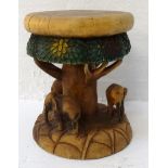 CARVED ELM STOOL with a circular seat and frieze carved to represent a tree and its canopy, with