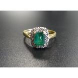 EMERALD AND DIAMOND CLUSTER RING the central emerald cut stone in diamond surround, on eighteen