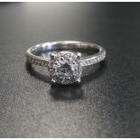 DIAMOND CLUSTER RING BY ROX the central round brilliant cut diamond approximately 0.3cts in