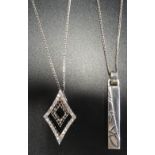 TWO SILVER PENDANTS one of diamond shape set with marcasite and CZ, the other with motif decoration,