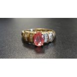 PINK GEM (POSSIBLY SAPPHIRE) AND DIAMOND DRESS RING the central oval cut pink gemstone flanked by